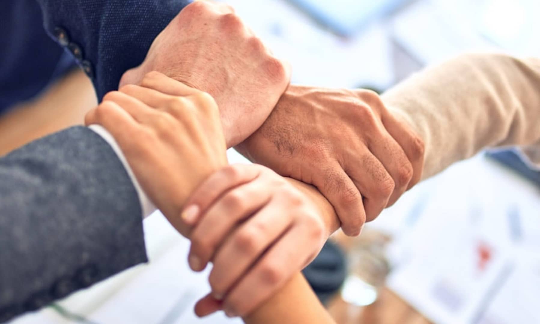 person in black long sleeve shirt holding persons hand