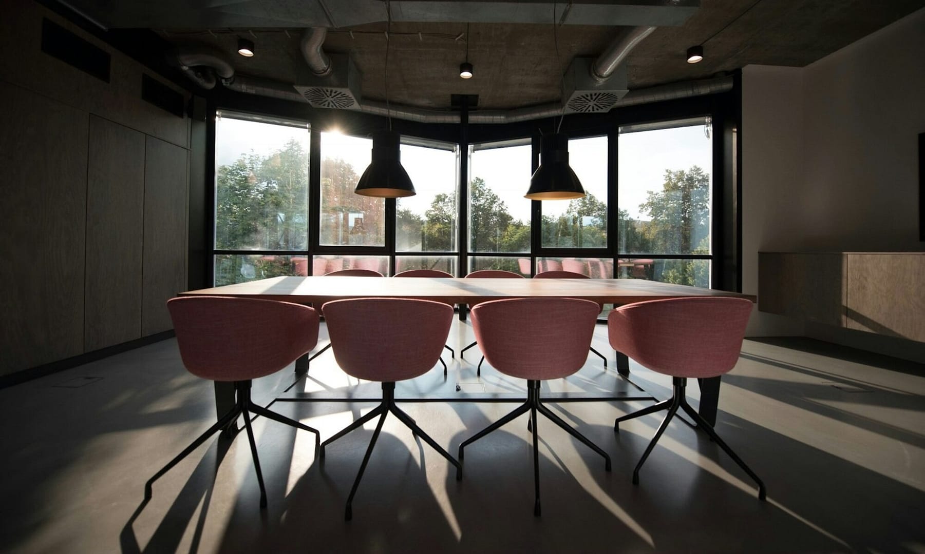 pink dining table with four chairs inside room